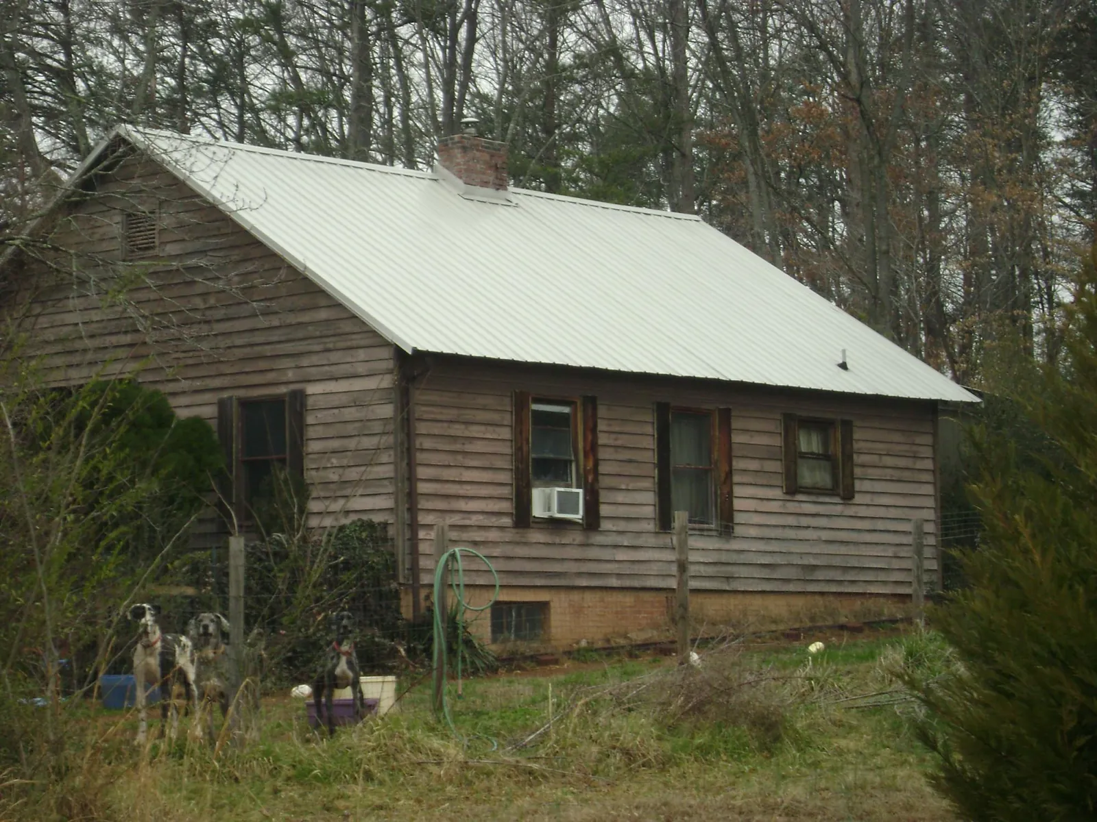 White metal roof on an old wood sided farmhouse, from a Metal Roof Installation job in Stryker